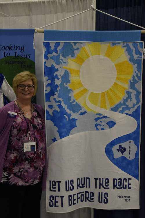 President Frances with Texas District banner