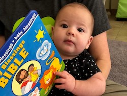 infant with Bible story book