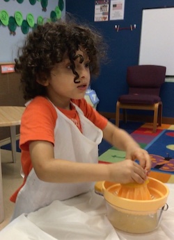 child juicing oranges