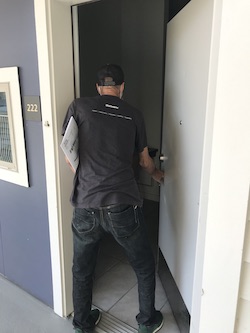 man entering door of apartment