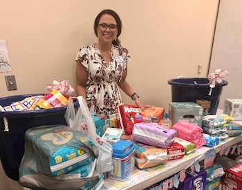 Melanie Rios with gifts for Any Baby Can